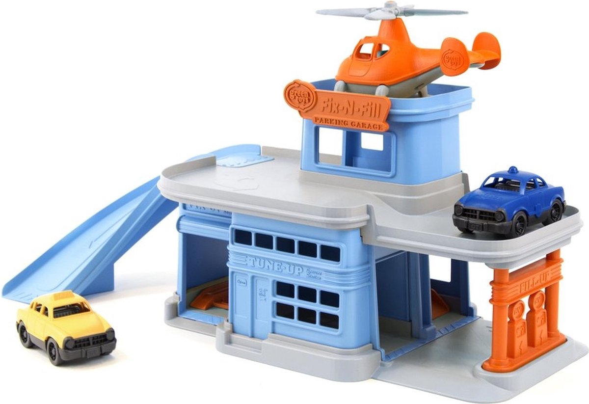 Grünes Spielzeugparkhaus mit Autos und Hubschrauber