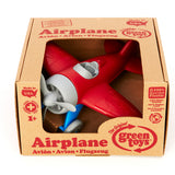 Grünes Spielzeugflugzeug - rot