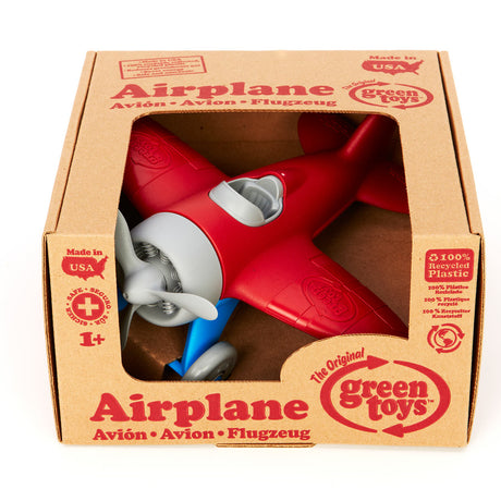 Grünes Spielzeugflugzeug - rot