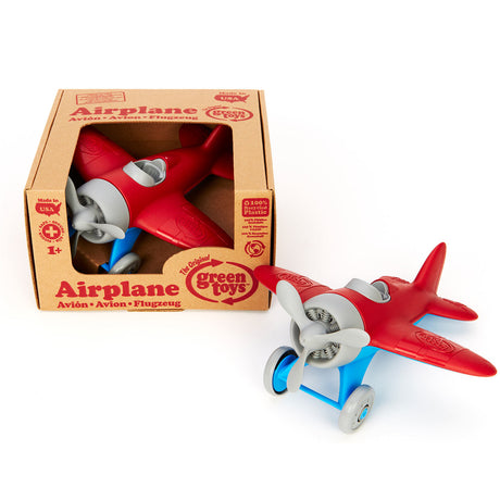 Grünes Spielzeugflugzeug - rot