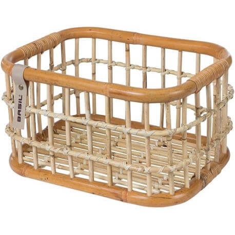 Basil Green Life rattan bicycle basket medium in front of natural brown